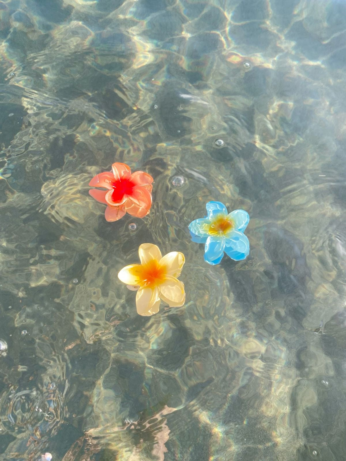 Sunny Clips flower hair clips in ocean water